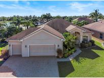 Single-story home with two-car garage and landscaped yard at 4345 Heath Land Ln, Lake Wales, FL 33859