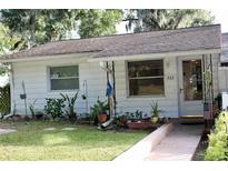 Charming single-story home with a well-maintained lawn and mature trees at 532 W Wisconsin Ave, Deland, FL 32720