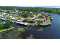 Waterfront community with boat docks on a scenic lake with lush greenery, offering a serene lifestyle at 1640 Juno Trl # 205A, Astor, FL 32102