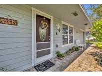 Inviting front porch with brick pavers, potted plants, and a charming door at 4430 Doris Dr, New Smyrna Beach, FL 32169