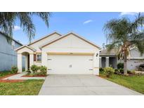 Charming single-story home with a two-car garage, lush landscaping, and a well-manicured lawn at 2924 Taton Trce, New Smyrna Beach, FL 32168