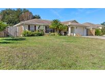 Single-story home with a well-maintained lawn and wooden fence at 2392 Laredo Dr, Deltona, FL 32738