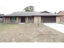 Brick ranch house with carport and mature landscaping at 641 Fairhaven St, Deltona, FL 32725