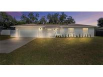 Charming single-story home with a well-manicured lawn, garage, and inviting front entrance at 7360 Canal Dr, Sanford, FL 32771