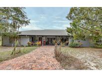Ranch-style home with metal roof and brick walkway at 180 Robinson Ln, Seville, FL 32190