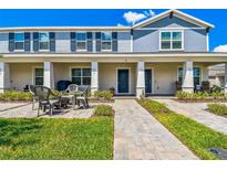 Charming townhome exterior with a cozy patio area and well-maintained landscaping at 635 Belgrove St, Debary, FL 32713