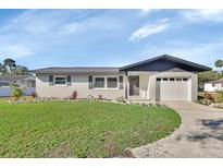 Newly renovated single-story home with a modern exterior and spacious lawn at 3070 Grand Ave, Deland, FL 32720