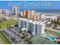 Ocean Terrace Club condo building aerial view, showing pool, tennis court, and parking at 3800 S Atlantic Ave # 4080, Daytona Beach, FL 32118