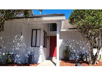 Inviting exterior with red front door, landscaping, and walkway at 101 N Hill Ave # 11, Deland, FL 32724