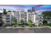Three-story building with ample parking and landscaping at 1100 Delaney Ave # F200, Orlando, FL 32806
