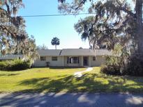 Ranch style home with mature landscaping and a large front yard at 1848 Ridgewood St, Deland, FL 32720