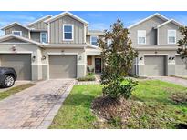 Charming townhome featuring a private garage, covered entry, and manicured lawn in a desirable neighborhood at 2353 Carrabelle Way, Sanford, FL 32771