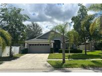 Charming single-Gathering home featuring a well-manicured lawn and a two-car garage at 2911 Wild Pepper Ave, Deltona, FL 32725