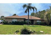 Charming brick home with well-maintained lawn and lovely landscaping at 2994 Annez Way, Debary, FL 32713