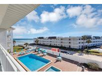 Oceanfront condo complex featuring a refreshing pool; steps to the beach at 3509 S Atlantic Ave # 301, New Smyrna Beach, FL 32169