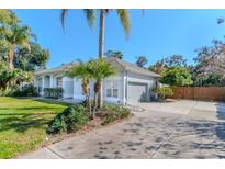 Charming single-story home with a gray facade, a well-kept lawn, and a paved driveway at 419 Still Forest Ter, Sanford, FL 32771