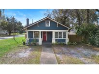 Charming bungalow with blue siding, red door, and walkway at 448 E Church St, Deland, FL 32724