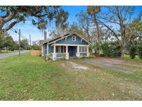 Charming blue bungalow with front porch and lush landscaping at 448 E Church St, Deland, FL 32724