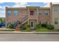 Brick building exterior, featuring a red door and stairs at 117 N Garfield Ave # 1, Deland, FL 32724