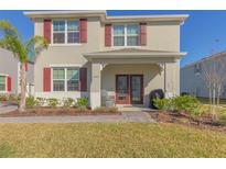 Two-story house with red shutters, double doors, and a landscaped yard at 3033 Meleto Blvd, New Smyrna Beach, FL 32168
