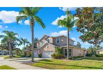 Two-story house with three-car garage and lush landscaping at 310 La Creek Ct, Debary, FL 32713