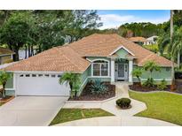 Charming single-story home with a well-manicured lawn, mature landscaping, and a two-car garage at 39 Ormond Green Blvd, Ormond Beach, FL 32174