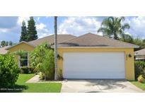 Single-story house with attached garage and landscaped yard at 222 Oak Branch Dr, Edgewater, FL 32141