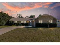 Attractive single-story house with sunset in the background at 373 Blythville Ave, Deltona, FL 32725
