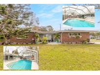 Charming single-story home featuring a screened-in pool and well-maintained landscaping at 559 Eagle Dr, Daytona Beach, FL 32117