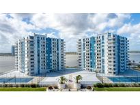 Aerial view of waterfront property with tennis courts and pool at 925 N Halifax Ave # 1001, Daytona Beach, FL 32118