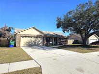 One-story house with a two-car garage and a spacious front yard at 1387 Hensley Dr, Deland, FL 32724