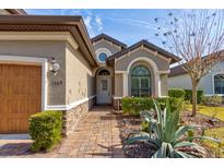 Front entry with a walkway, landscaping, and architectural details at 3169 Connemara Dr, Ormond Beach, FL 32174