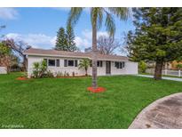 Newly renovated single-story home with a landscaped lawn and driveway at 916 Tracy St, Daytona Beach, FL 32117