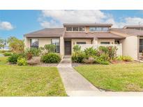 Front view of charming villa with well-manicured landscaping at 1260 Charter Oaks Cir, Daytona Beach, FL 32117
