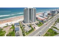 Aerial view of beachfront high-rise building with ocean and road views at 1420 N Atlantic Ave # 1102, Daytona Beach, FL 32118