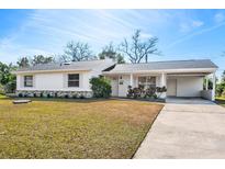 Charming single story home with carport and well-manicured lawn at 1612 Beatrice Dr, Orlando, FL 32810