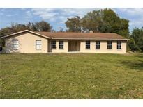 Charming single-story home with a manicured lawn and a welcoming double-door entryway at 1870 S Lehigh Dr, Deltona, FL 32738