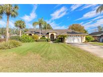 Charming single-story home with a well-manicured lawn and lush landscaping at 1930 Seclusion Dr, Port Orange, FL 32128