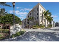 Tuscan Square Condominiums building with palm trees and gated entrance at 424 Luna Bella Ln # 332, New Smyrna Beach, FL 32168