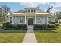 Charming single-story home with a welcoming front porch and well-maintained landscaping at 475 W Main St, Lake Helen, FL 32744
