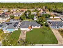 Aerial view of a charming single-story home with a lush lawn and a neatly maintained landscape at 728 Vicksburg St, Deltona, FL 32725
