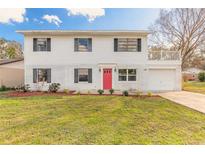 Charming two-story home featuring a bright red door, lush lawn, and a brick facade at 1195 10Th St, Daytona Beach, FL 32117