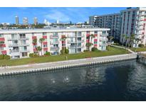 Waterfront condo building with lush landscaping, dock, and city skyline views at 2711 N Halifax Ave # 463, Daytona Beach, FL 32118