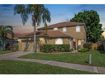Charming two-story home with well-maintained lawn, mature landscaping, and inviting curb appeal at 3633 Sickle St, Orlando, FL 32812