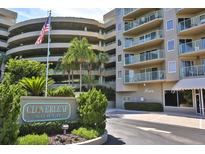 Cloverleaf North community entrance with lush landscaping and parking at 4 Oceans West Blvd # 502D, Daytona Beach Shores, FL 32118