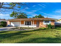 Charming single-story home with a well-manicured lawn and attached two car garage, offering suburban appeal at 1216 Sunland Rd, Daytona Beach, FL 32114