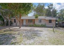 Charming single-story brick home with a cozy front yard and mature trees providing shade at 137 Lucerne Dr, Debary, FL 32713