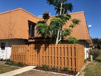 Charming exterior featuring a wooden fence, balcony, and unique roof design at 179 Moonstone Ct, Port Orange, FL 32129