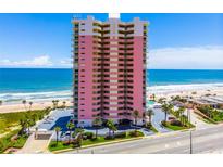 Stunning beachfront condominium with ocean views, a pool, a parking area, and tropical landscaping at 1900 N Atlantic Ave # 901, Daytona Beach, FL 32118
