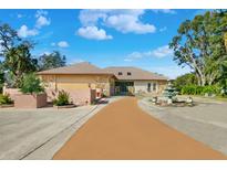 Charming single-story home featuring stone accents and a lush, landscaped front yard with a water feature at 1924 Seclusion Dr, Port Orange, FL 32128